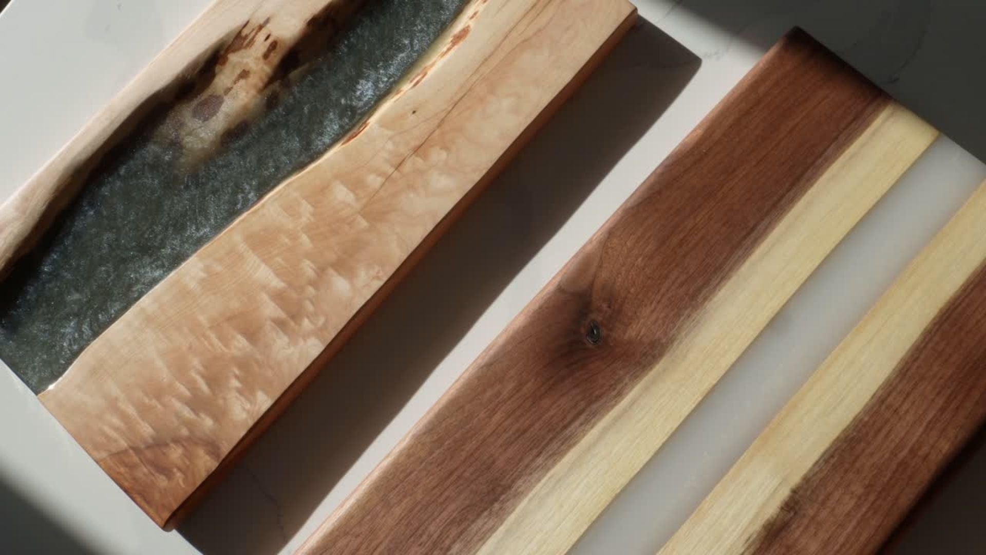 Load video: Products made by us, available now. These products have been displayed in a more photogenic space, gearing for a more aesthetic look. There are epoxy river boards, hornbeam, walnut, and cherry, a maple and epoxy coffee table, aswell as a walnut desktop.